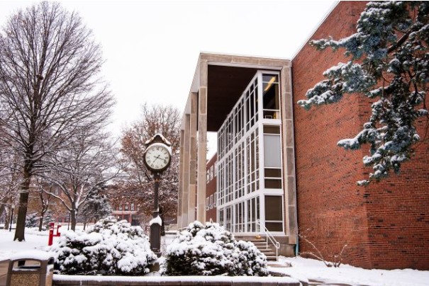 Old Union building with clock in foreground after light snow